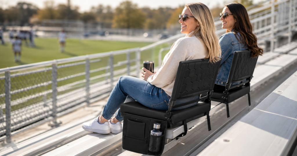 Mother's enjoying a scoccer game comfortably using cushioned stadium seats
